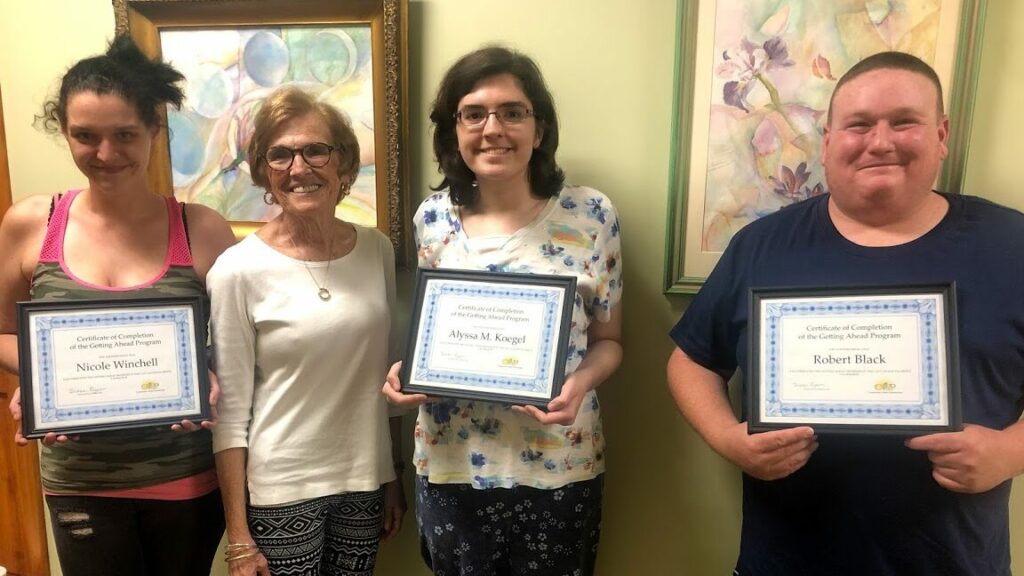 people posing with certificates