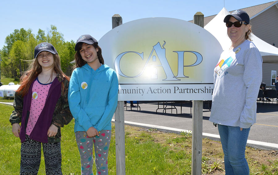 cap mentees pose with sign